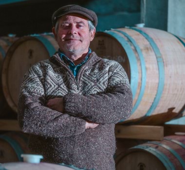 Tasmanian winemaker Stefano Lubiana stands before a wine barrel