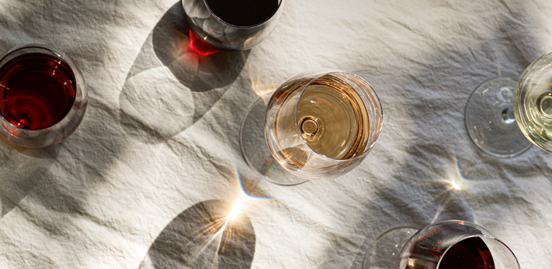 An overhead view of glasses of wine upon a table