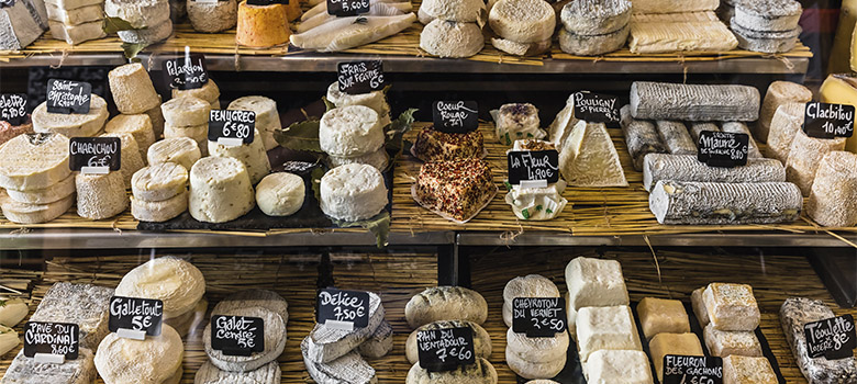 A daily delicacy in France, visiting a classic fromagerie (cheese) market stall with all the goods.