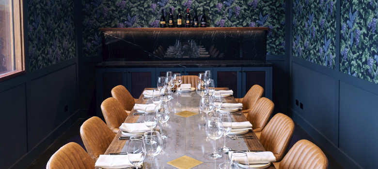Table set with plates, cutlery and wine glasses
