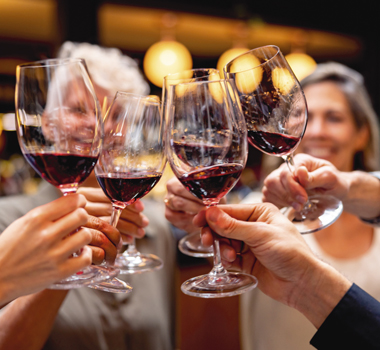 Glasses of red wine being held up together