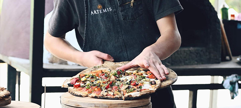Chef cooking wood-fired pizza at Artemis Wines in the Southern Highlands