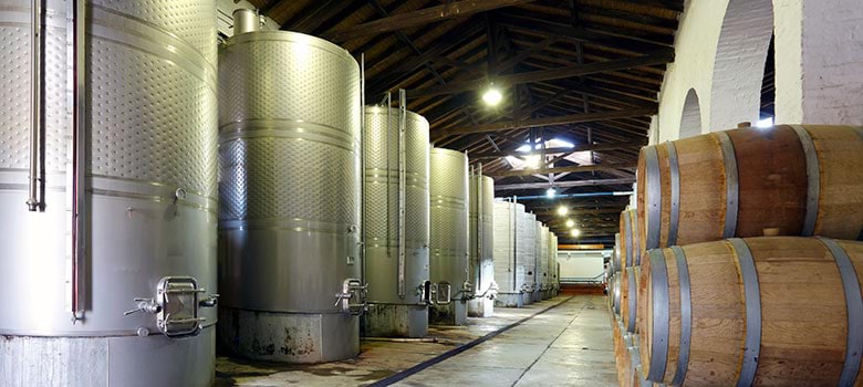 Sparkling wine barrels in a barrel room