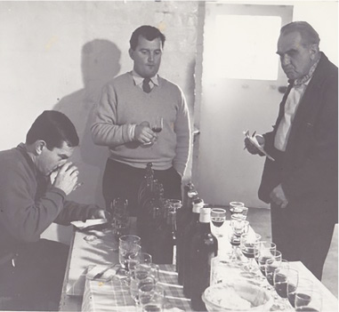Len Evans, Rudy Komon and Frank Morgan tasting wine at a wine show.