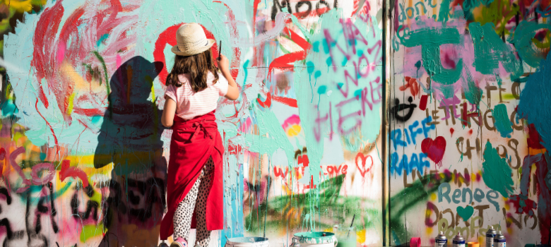A young artist painting a mural at the Penola Coonawarra Arts Festival, a major annual draw card for cultural explorers.