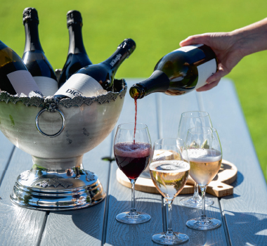A tasting session at DiGiorgio, with wines being poured at a table on the grounds of the estate.